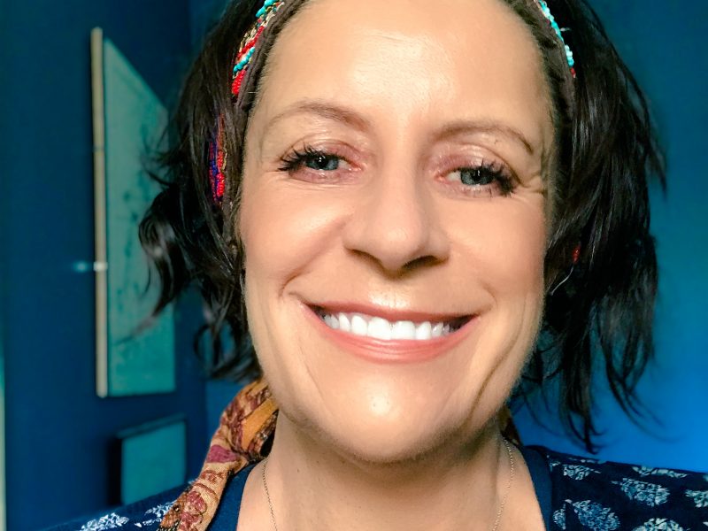 smiling woman pondering what to be grateful for