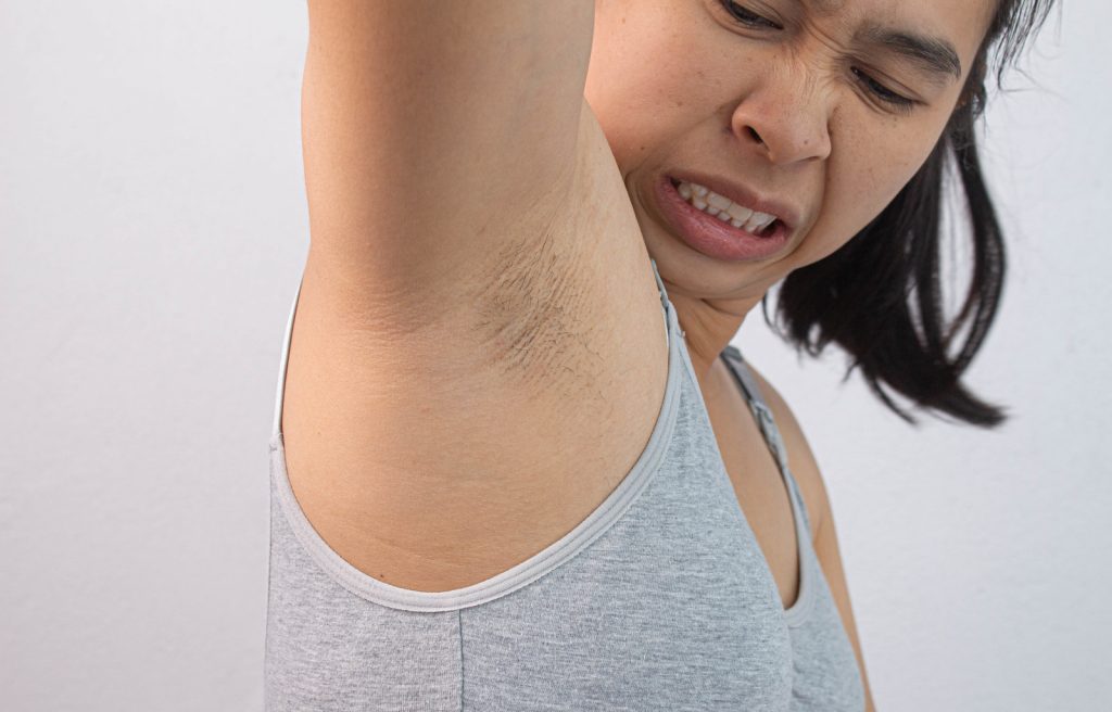 woman smelling her armpits