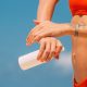 woman putting sunscreen on